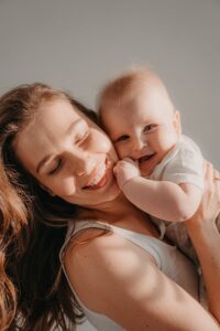 Smiling mother holding an infant