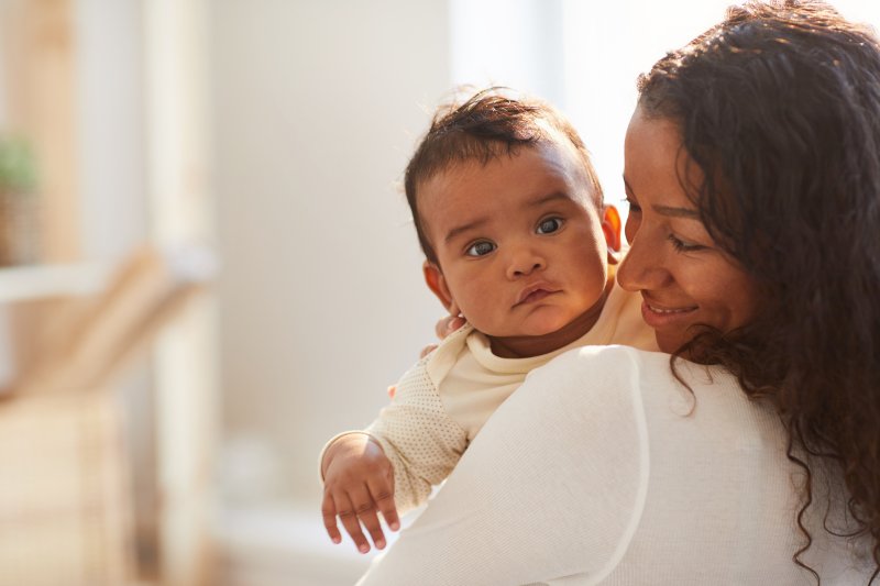 a mother holding her baby