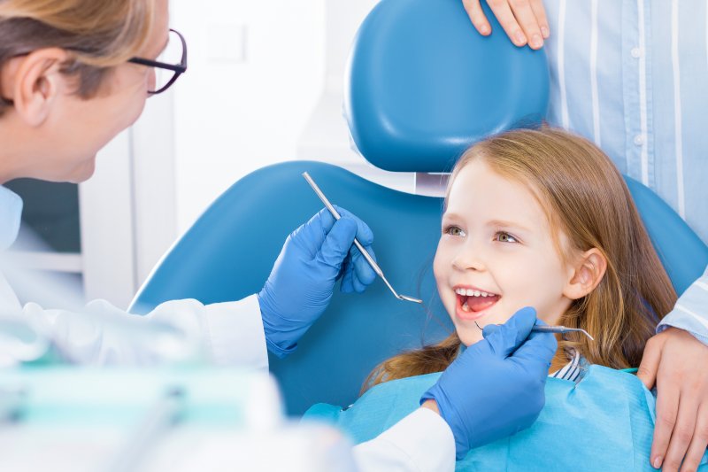 Cute kid smiles in dentist chair